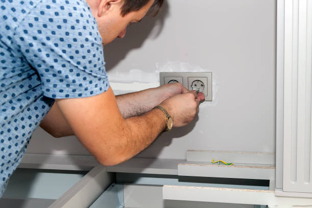 istock handyman removes the frame from the electrical outlet to fix the problem 1373080684