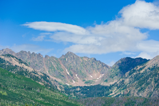 Gore Range Mountains in Summer Vail Colorado.  View of iconic Grand Traverse Peak showing the Grand Traverse on a sunny summer day.  Rugged mountains and peaks make for scenic landscape with copy space.  Captured as a 14-bit Raw file. Edited in ProPhoto RGB color space.