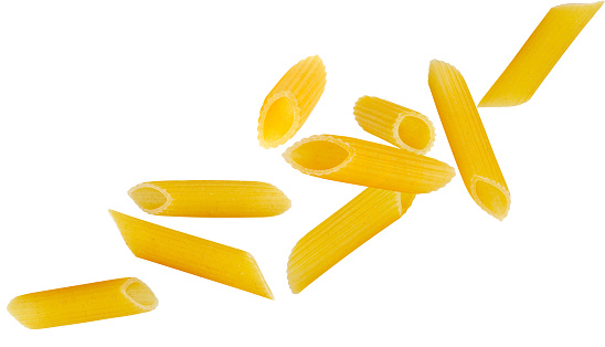 Italian pasta penne rigate flying in space isolated on white