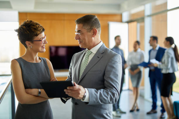 istock Two business people discussing business strategy using digital tablet 1373085765
