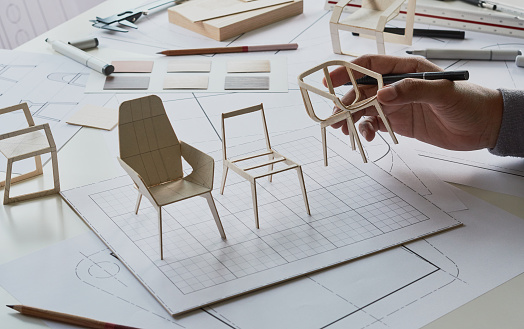 Designer sketching drawing design development product plan draft chair armchair Wingback Interior furniture prototype manufacturing production. designer studio concept .