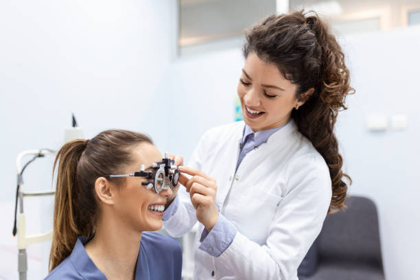 istock Eye health cheking with ophthalmological equipment in the laboratory. Using special device oculist trying to improve vision of young pretty girl. Working with medical devices for eye health. 1373089055