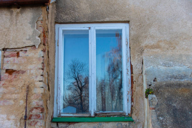 istock Old wooden window in a dilapidated wall 1373089113