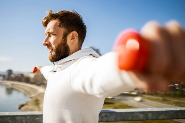 istock Young athlete exercising lifting dumbbells 1373090954