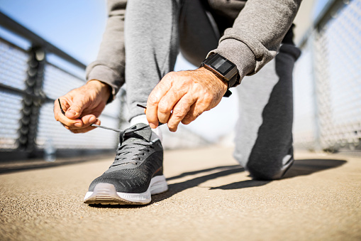 Senior runner ties the shoelace