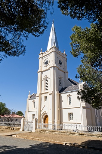 NG Church with clock tower in Bethulie, Free State, South Africa framed by trees