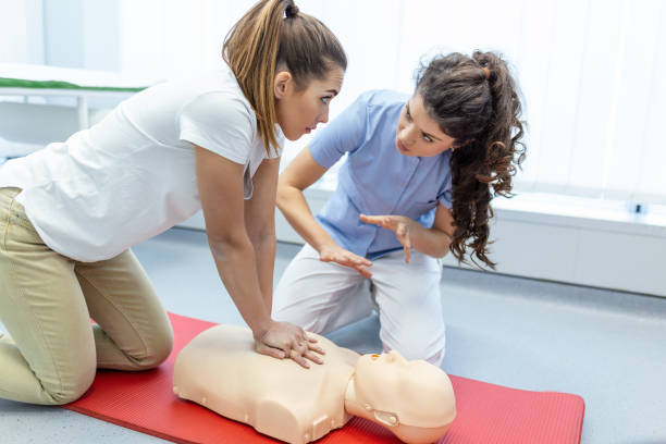 Nursing students are learning how to rescue the patient in emergency. CPR training with CPR doll. Closed-up. Soft focus. Nursing students are learning how to rescue the patient in emergency. CPR training with CPR doll. Closed-up. Soft focus. first aid class stock pictures, royalty-free photos & images