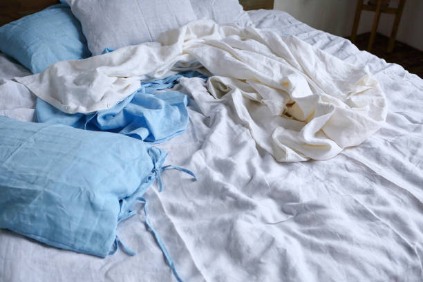 Natural linen bedroom"nsheet textile duvet cover white and blue stock photo