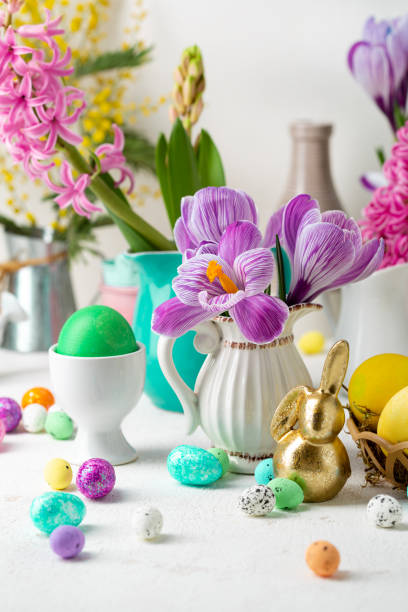 istock Spring flowers and golden Easter bunny colour eggs 1373095334