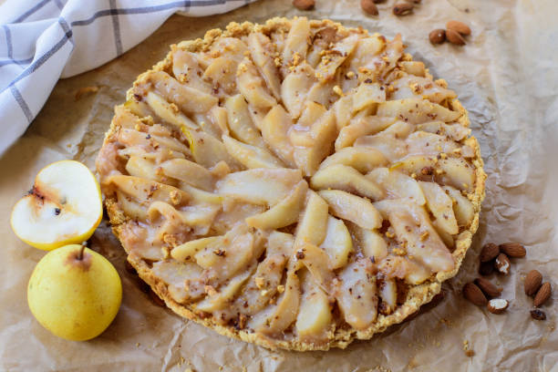 istock Traditional pear sliced fruit pie with nuts and sugar powder. 1373097085