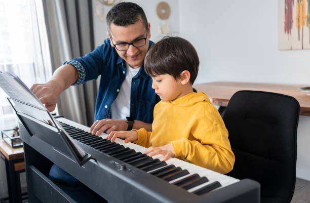 the piano lesson - practicing piano child playing imagens e fotografias de stock