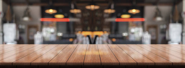 istock Empty wooden table top with lights bokeh on blur restaurant background. 1373100578