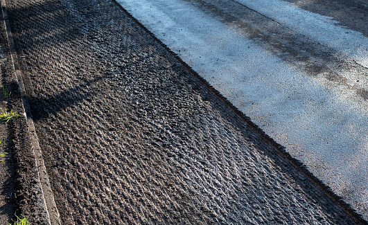 the milled surface of a damaged asphalt road prepared for reconstruction