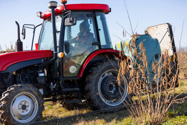 Young African Female Farmer Is Riding Tractor With Mounted Sprayer