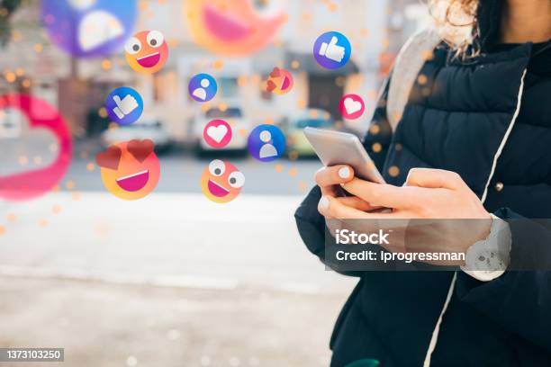 Social Media Concept Woman Using Smartphone Outdoors Stock Photo - Download Image Now