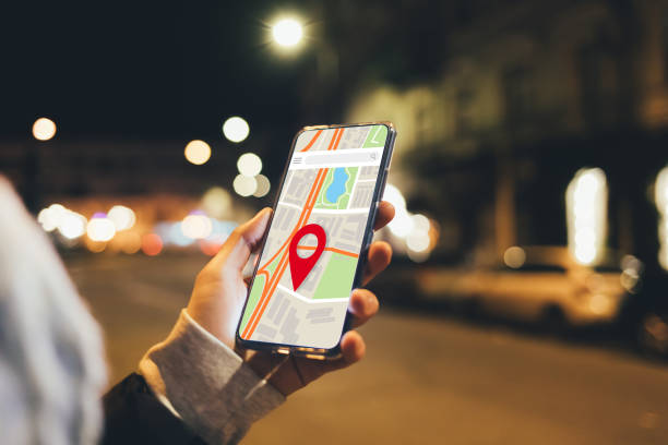 istock Woman using map application in smartphone to navigate city 1373103266