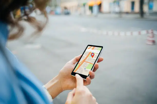 Photo of Woman tourist use maps app to navigate city
