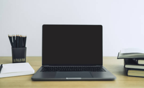 istock Blank screen laptop with book or textbook. Business and education 1373105652