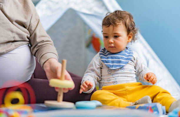istock Boy playing at home whit his pregnant mother 1373109595