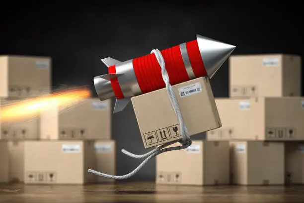 Photo of Fast delivery packet or parcel concept. Rocket with cardpoard box.