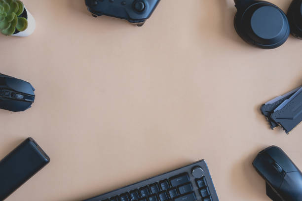 istock gamer work space concept, top view a gaming gear, mouse, keyboard, joystick, headset, mobile joystick, in ear headphone and mouse pad on black table background. 1373109746