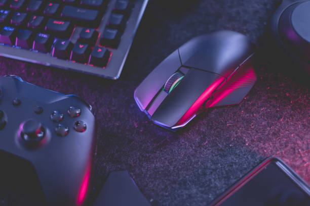 istock gamer work space concept, top view a gaming gear, mouse, keyboard, joystick, headset, mobile joystick, in ear headphone and mouse pad on black table background. 1373109753