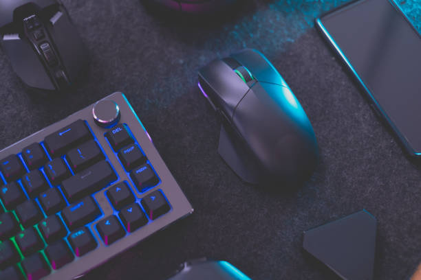 istock gamer work space concept, top view a gaming gear, mouse, keyboard, joystick, headset, mobile joystick, in ear headphone and mouse pad on black table background. 1373109755