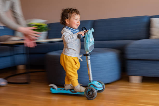 istock Cute boy whit push scotter at home 1373109877