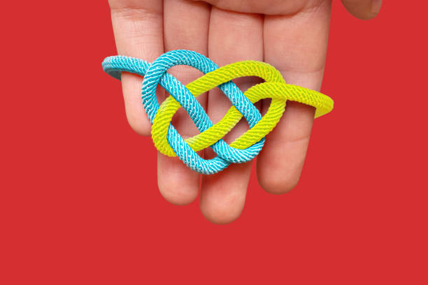istock Heart shaped celtic knot in hand isolated on red 1373110948