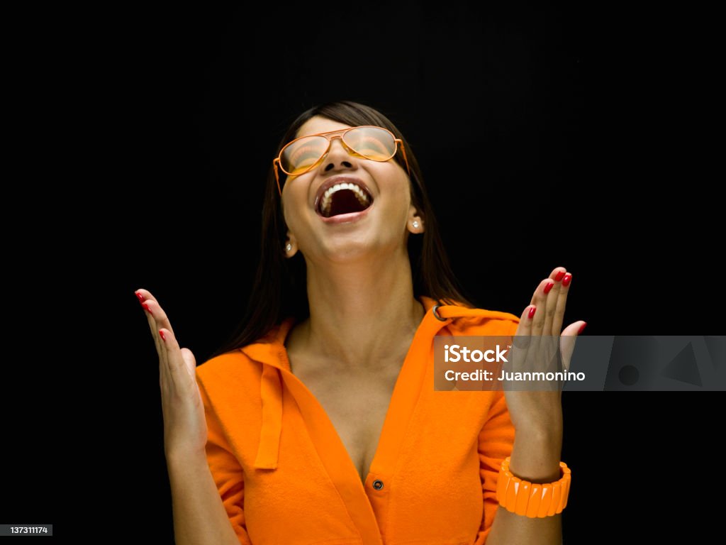 Cheerful hispanic young woman Cheerful hispanic young woman looking up on black background (this picture has been taken with a Hasselblad H3D II 31 megapixels camera) Portrait Stock Photo