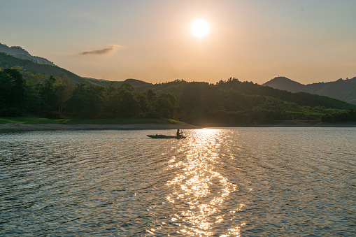 Fisherman on Lang Nhot lake in sunset, Khanh Hoa province, central Vietnam