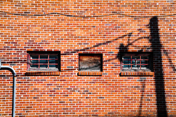 istock brick wall downtown rural store bushiness abandoned empty closed closure rundown retro vintage windows town shadows facade 1373113064