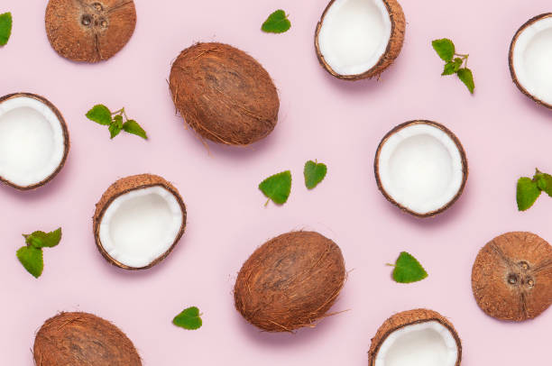 istock Pattern with ripe coconuts and mint leaves on pink background minimal flat lay style. Tropical abstract background Top View Copy Space. Pop art design, creative summer and Food concept. 1373116930