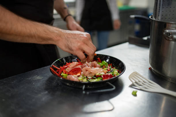 istock Unrecognizable chef preparing meal indoors in restaurant kitchen. 1373120949