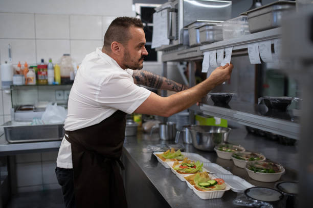 istock Chef taking order slip in commercial kitchen. 1373121235