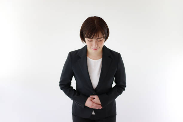 Female employee bowing Female employee bowing bowing stock pictures, royalty-free photos & images
