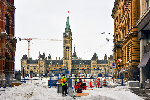 Ottawa, Canada - February 26, 2022: A fence remains in place one week after police cleared the area near Parliament Hill of trucker convoy protesters. Much of the fencing has been taken down but some of it remains near Wellington Street, and other strategic areas.