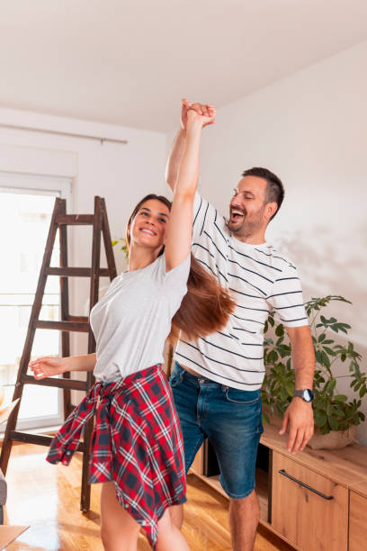 istock Couple in love dancing while moving in together 1373127378