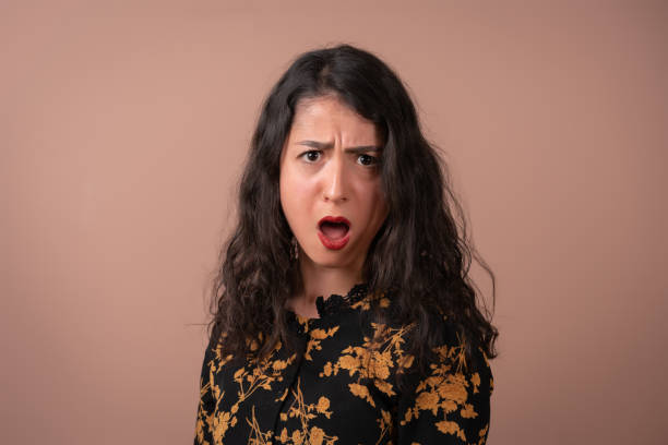 istock Surprised  young woman looking at the camera 1373130423