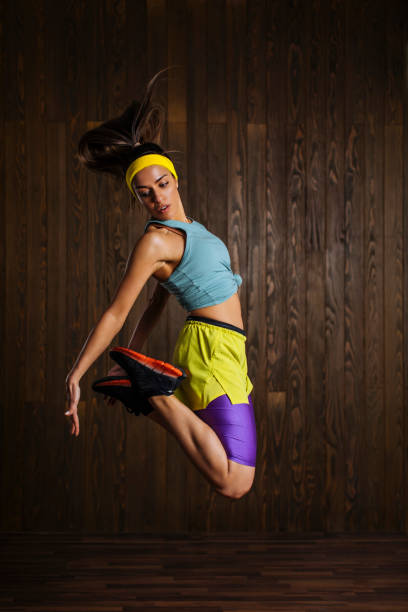 A photo of a girl caught in a jump while working out