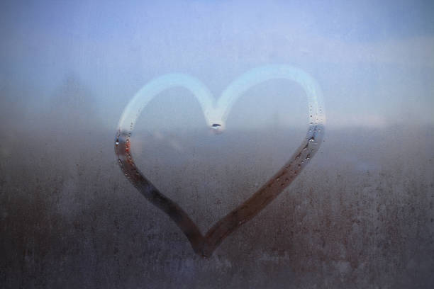 istock Finger drawn heart on glass. Close-up. Background. Texture. 1373130897