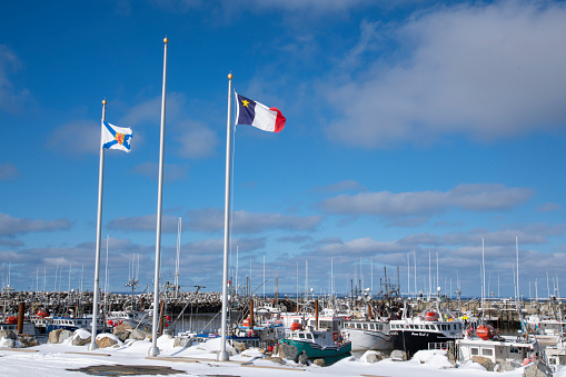 Meteghan, Nova Scotia, Canada - February 26, 2022: Commercial fishing boats in the harbour in Meteghan, Nova Scotia. Meteghan is an active fishing port on the French Shore of Clare County. The area is steeped in Acadian history and culture and it's connection to the sea.