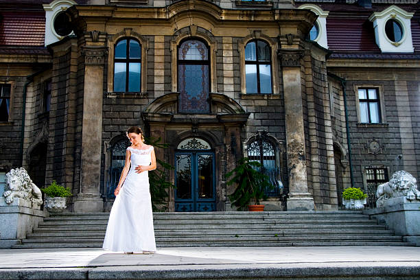 Young classy woman standing on palace terrace.