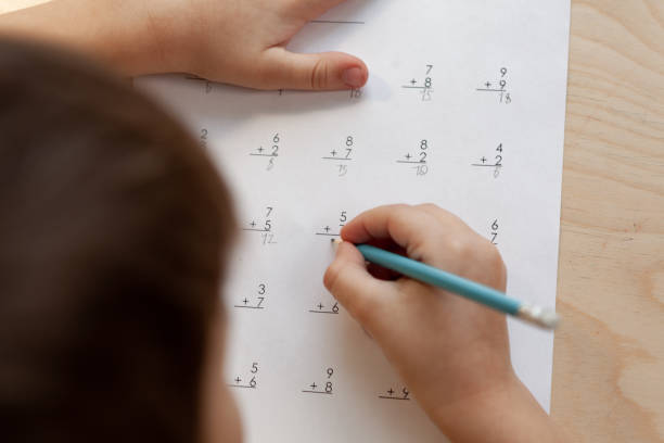 istock A schoolboy doing math lesson sitting at desk in the children room 1373131493