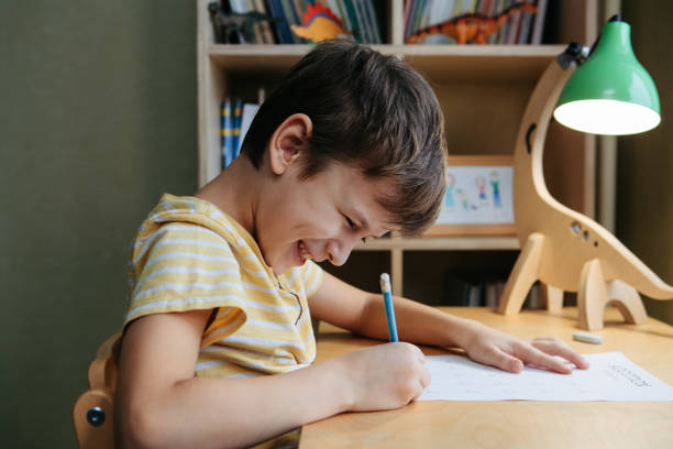 istock A schoolboy doing math lesson sitting at desk in the children room 1373131752