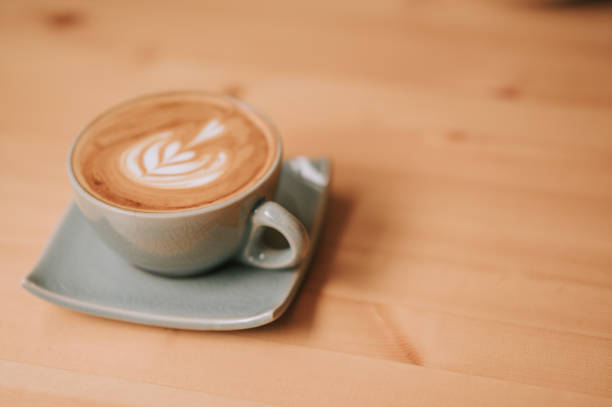 istock Coffee with flower deco on a wooden table 1373133105