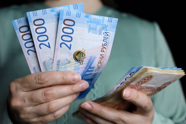 Russian rubles in female hands, cash pay, salary, inflation or savings concept stock photo
