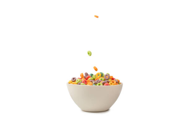 istock Colorful cereal box for morning breakfast. Corn flakes falling to the white bowl. Motion. 1373133356