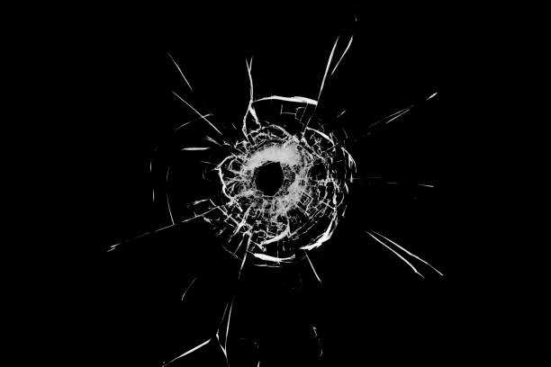 istock Texture of broken glass. Hole from a ball on a black background. 1373135285