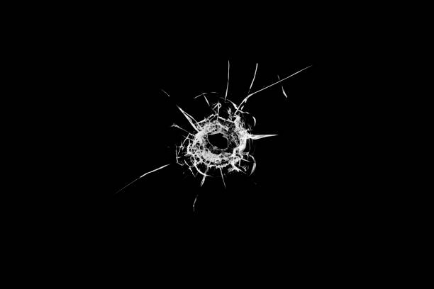 istock Texture of broken glass. Hole from a ball on a black background. 1373135381